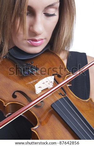A close up of a beautiful woman playing the violin set against a white background
