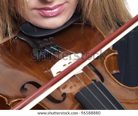 A close up of a woman playing a concert violin