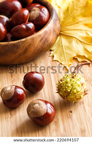Sweet chestnuts in a bowl and on a wooden board