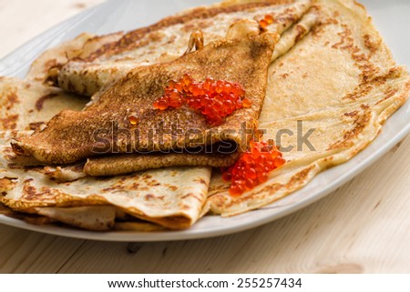 plate with pancakes and red caviar