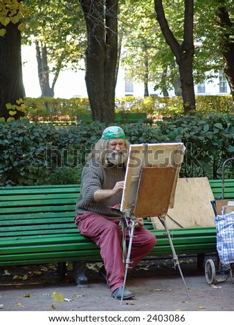 a painter in the summer garden. saint-petersburg. russia