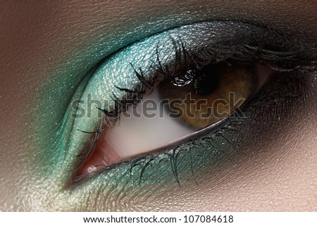 Elegance close-up of female eye with mint color eyeshadow. Macro shot of face part