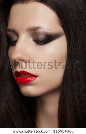 Close-up portrait of sexy caucasian young woman model with glamour red lips make-up, eye arrow makeup, purity complexion. Perfect clean skin. Retro beauty style