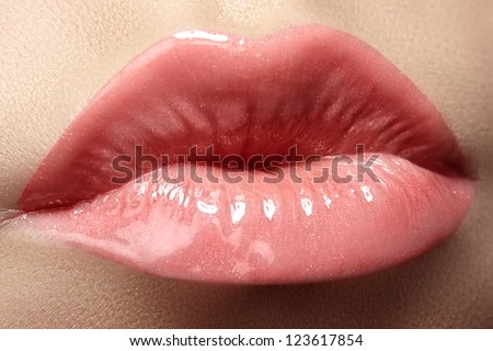 Sweet kiss. Sexy pink wet lip makeup. Close-up of beautiful full lips