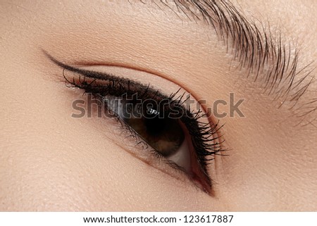 Cosmetics & make-up. Beautiful female eye with black liner makeup