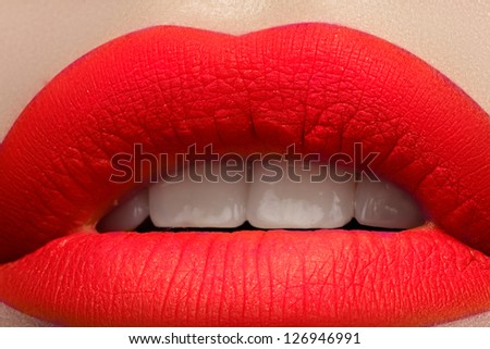 Close-up of beautiful full woman\'s lips with bright fashion mat pink makeup. Horizontal macro shot with magenta frosted lip make-up