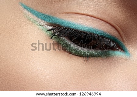 Elegance close-up of beautiful female eye with fashion trend mint colors eyeshadow and eyeliner. Macro shot of beautiful woman\'s face part with makeup. Cosmetics, beauty and make-up