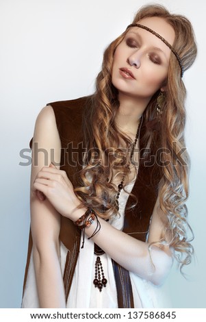 Bohemian woman in spring and summer clothes with beautiful accessories, natural make-up and shiny hairstyle. Fashion hippie style. Long curly hair.