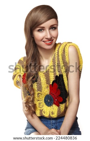 Beautiful girl in nice retro knitted sweater and denim jeans. Fashion tender style, bright lips make-up. Studio portrait of cute woman with long curly hair. Happy smiling model. Happiness smile