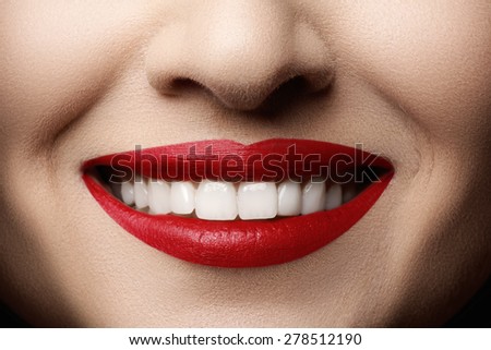 Close-up happy female smile with healthy white teeth, bright magenta lips make-up. Cosmetology, dentistry and beauty care. Macro of woman\'s smiling mouth. Beautiful smile