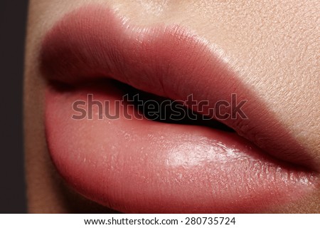 Close-up of woman\'s lips with fashion natural beige lipstick makeup. Horizontal macro sexy pale lipgloss make-up