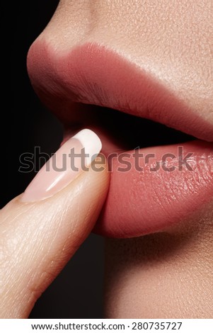 Close-up of full woman\'s lips with natural light makeup. Beauty macro sexy female mouth and french manicure on nails. Naturel tender look