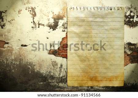 Old notebook paper on wall background