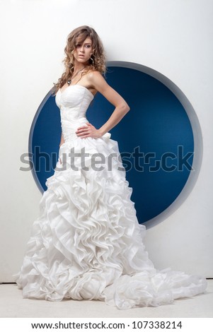Beautiful lady in wedding dress in hi-tech interior