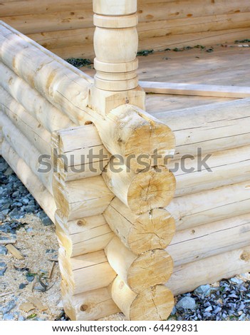Wall of a rural log house from the fresh cut logs