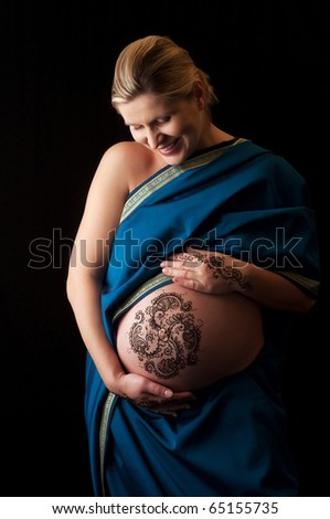stock photo : A photo of henna tattoo paste on a woman's hands and pregnant 