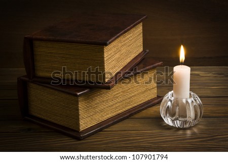 ancient books with candle