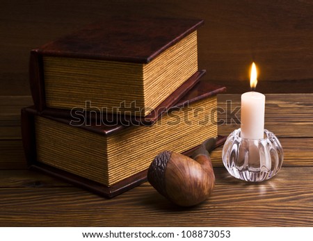 ancient books with candle