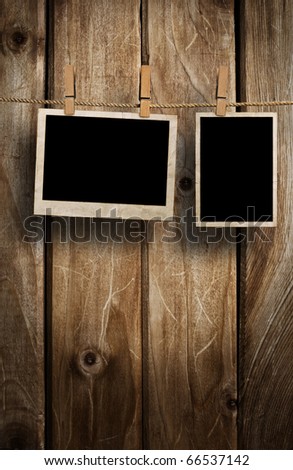 Aged photo frames on wood background