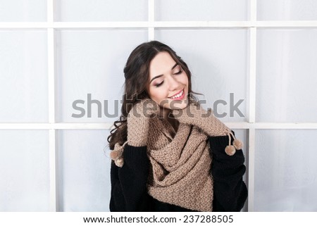 Cute girl in winter outfit posing for the camera. Christmas background