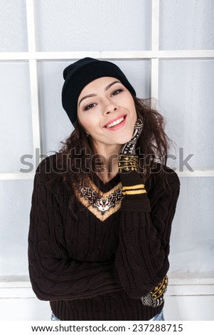 Cute girl in winter outfit posing for the camera. Christmas background