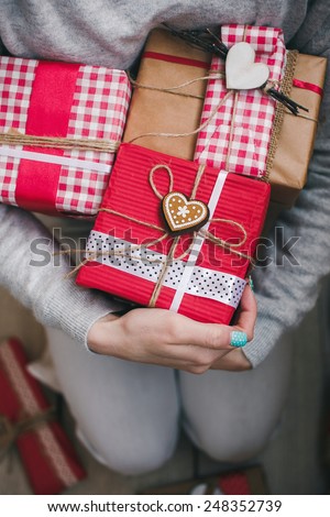 A lot of gifts on Valentine\'s Day in the hands of a girl