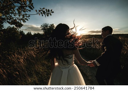 Lovely couple spends time in the field .Taken at sunset with natural light