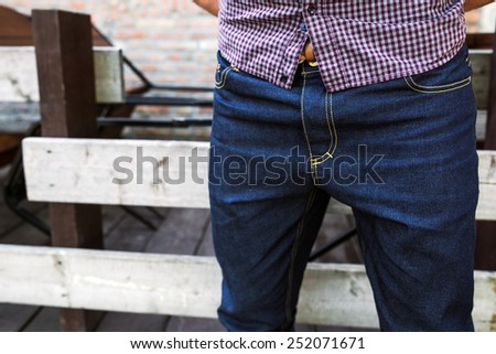 Lower Body  of Men dressed in selvedge jeans , retro shoes and plaid shirt. Vintage look