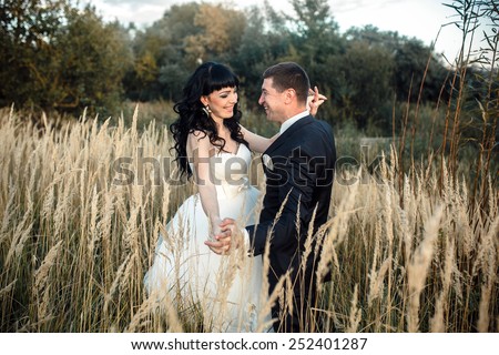 Lovely couple spends time in the field .Taken at sunset with natural light