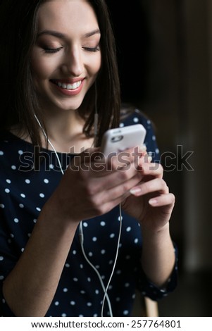 Beautiful girl works with nano  technologise on the phone and smiles