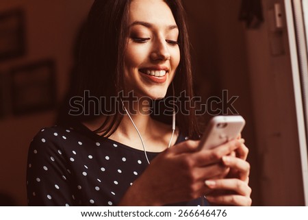 Beautiful girl works with  technologise on the phone
