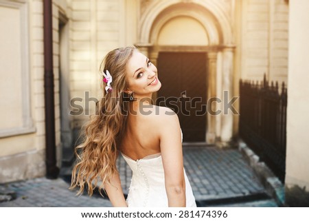 Beautiful bride posing against the backdrop of the ancient church