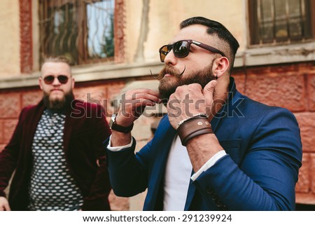 Two stylish bearded men on the background of the old town