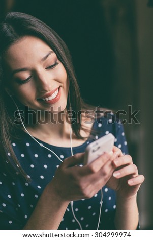 Beautiful girl works with  technologise on the phone and smiles