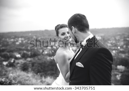 Wedding couple posing for the camera on the hump