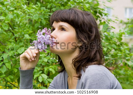 beautiful girl smell the lilacs, in nature