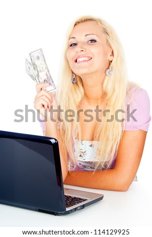 happy girl working with a laptop and keeps money