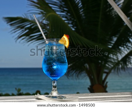 a blue cocktail in paradise