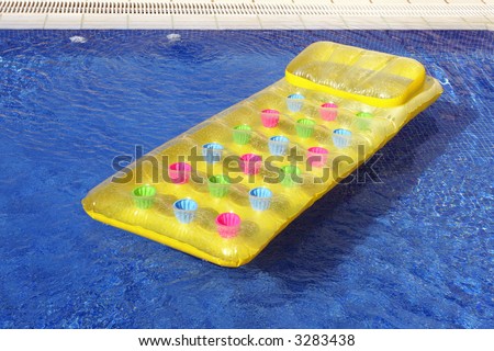 a lilo or inflatable air bed in a swimming pool