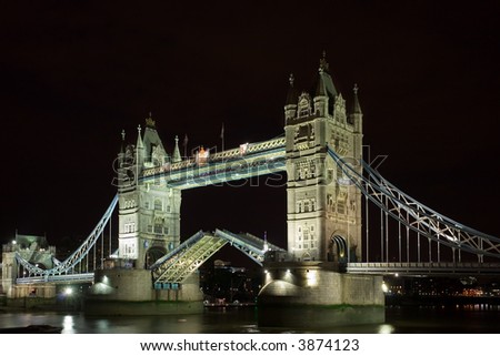 a night shot of tower bridge with the bridge raised