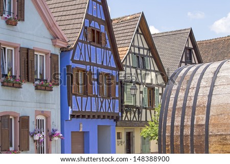 Alsace village, colorful houses with old vine barrel. France.