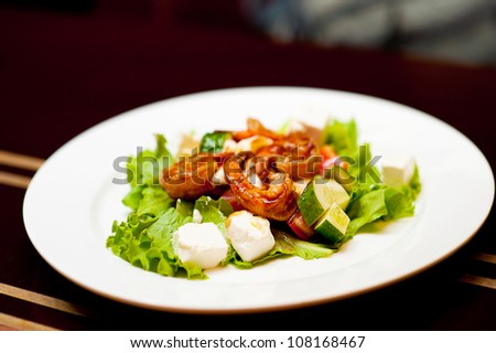 Healthy Salad with fried shrimp (prawn) in sauce at restaurant