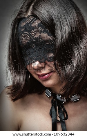 Sexy young woman with lace mask covered her eyes