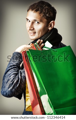 Fashion man holding shopping multicolored bags