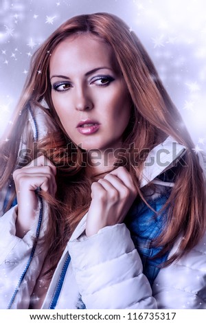 Fashion winter portrait of beautiful brunette woman in white jacket