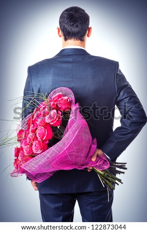 Valentines day. Man hiding behind a bouquet of flowers. Proposal scene