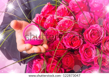 Valentines day. Man with flowers and ring in pink box. Proposal scene