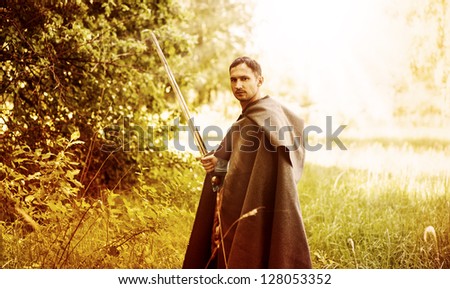 Fantasy portrait of handsome dangerous man with medieval sword