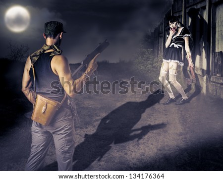 Military man with a gun looking at female zombie with a bloody ax