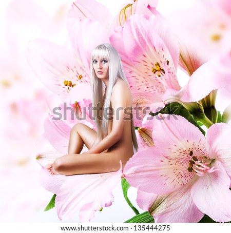 Beautiful sexy woman pixie sitting on a tender pink flower petal